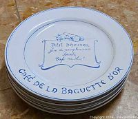 Stack of plates showing rim text and central design