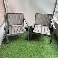 Both outdoor chairs on artificial grass surface