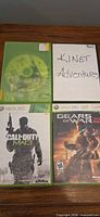 Four Xbox 360 games with cases and discs visible