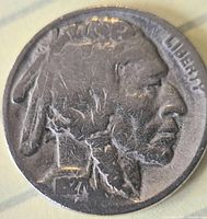 Obverse showing Native American portrait, date 1927 visible