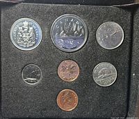 Open case showing all seven coins in flock insert