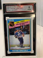 Front view of KSA slab displaying 1984-85 O-Pee-Chee Wayne Gretzky #381 card with grade 8 NMM