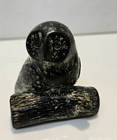 Front view of soapstone owl figurine showing overall form and etched details