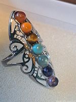 Top view of ring showing elongated shield and seven cabochon stones