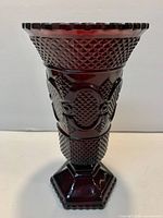Full view of ruby red pressed glass vase