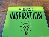 Front of green box titled The Big Box of Inspiration with lightbulb graphic