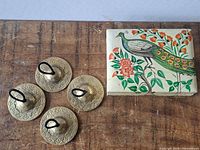 Overview of four brass finger cymbals and painted trinket box