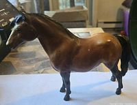 Left side view of brown Breyer horse figurine