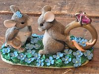 Full view of figurine with two mice and ring on floral base