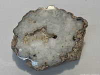 Top view showing polished face with druzy quartz and agate banding