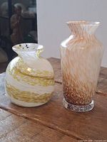 Both vases side by side on table