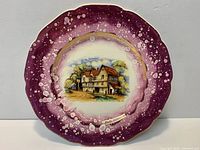 Front of Gray's Pottery plate showing purple splatter border, cottage transfer and gilt rim