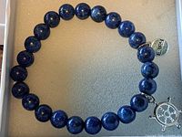 Top view of bracelet showing blue lapis beads and attached charms