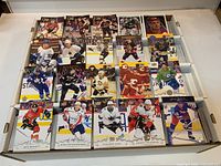 Top view of portion of cards spread in box showing player fronts and variety of sets