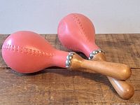 Pair of maracas showing heads and handles