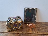 Overall view of jeweled box, rhinestone frame and copper elephant