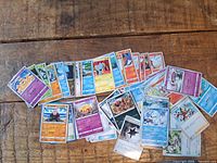 Fronts of assorted Pokémon, Trainer and Energy cards spread on table