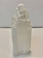 Full view of the selenite crystal tower showing shape, color and surface texture