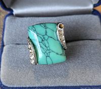 Front view of ring showing turquoise stone and rhinestone accents