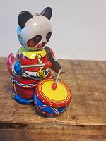 Front left view showing panda, drum, wind-up key