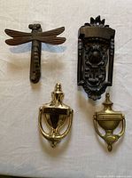 Front view of all four door knockers on cloth surface