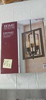Front of boxed Home Decorators Collection Palermo Grove 3-light pendant