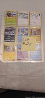 Nine-pocket binder page showing front side of assorted Pokémon cards