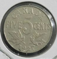 Reverse of 1927 Canadian 5-cent coin showing denomination, maple leaves and date