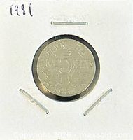 Reverse side of 1931 Canadian 5 cents coin in holder showing denomination and date