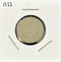 Coin in holder, reverse side showing denomination and date