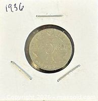 Coin in holder, obverse side showing King George V portrait