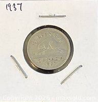 Full view of coin in holder with handwritten year