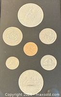 Seven coins displayed reverse side in original holder