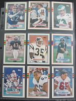 Nine 1989 Topps football cards in binder sleeve, fronts visible