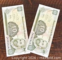 Two 10 centavos banknotes front side angled, both serial numbers visible