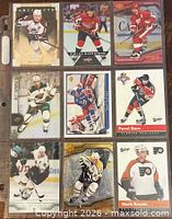 Nine trading cards in binder sheet (front view)