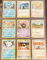 Front view of nine Pokémon cards in binder sheet