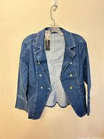 Front view of denim blazer on hanger