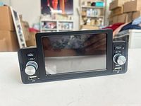 Front view showing 7-inch touchscreen, knobs, buttons and USB ports