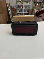 Front view of black Kwanwa digital LED alarm clock with red display lens