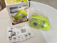 Toy, box, and manual displayed on table