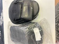 Pair of black focus mitts, one out of packaging, one sealed