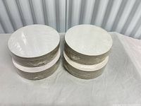 Four shrink-wrapped stacks of cake boards side view