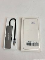 Hub in tray beside front of white retail box