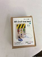 Front of sealed retail box showing product image and warnings