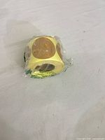 Roll of yellow round adhesive labels sealed in plastic