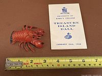 Dance card front and plastic lobster with ruler for scale