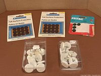 All five packages of furniture floor protectors displayed