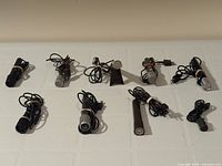 Six microphones laid out to show quantity and overall condition