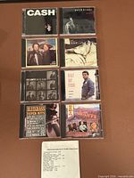 All nine CDs and paper insert arranged on surface